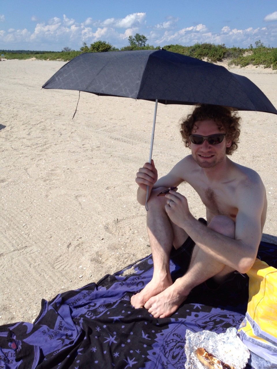 Photo of Big Mr. demonstrating the original use of the umbrella