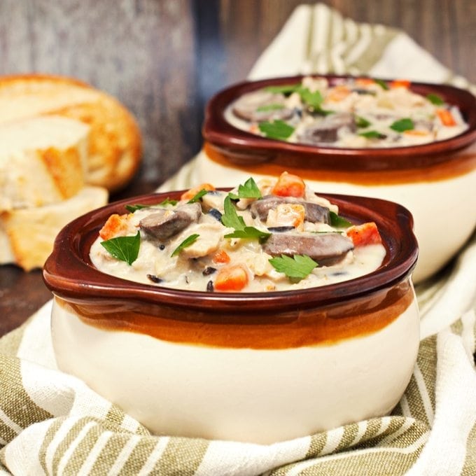 bread and creamy chicken rice soup topped with fresh parsley 