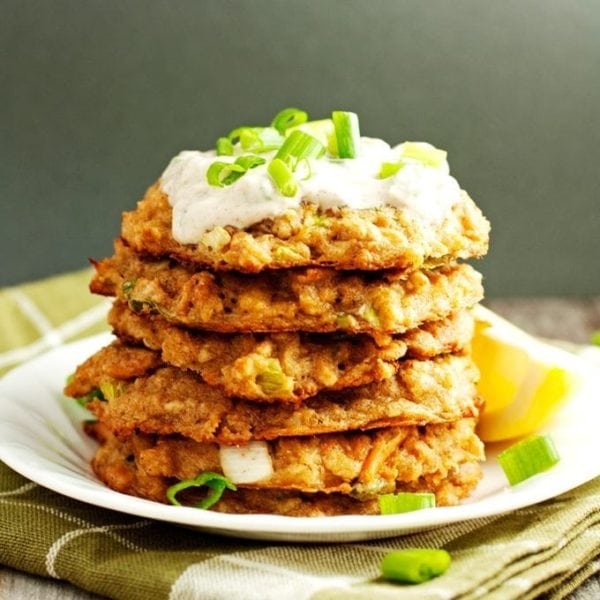 stack of baked crab cakes with yogurt sauce