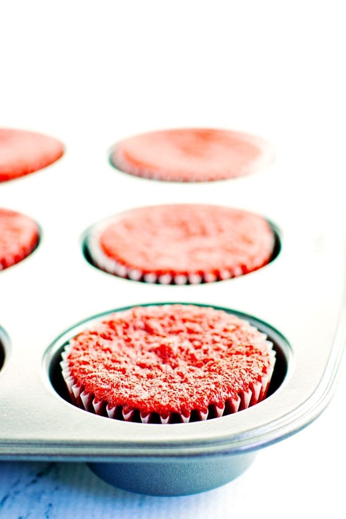 muffin tin of baked red velvet cupcakes