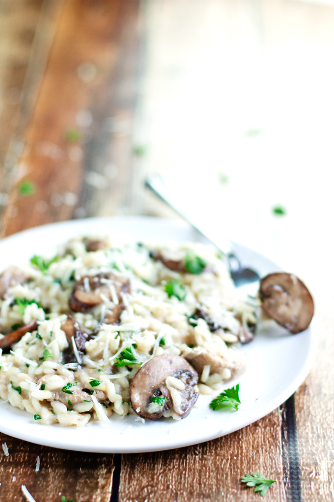 plate and fork full of creamy chicken and mushroom risotto